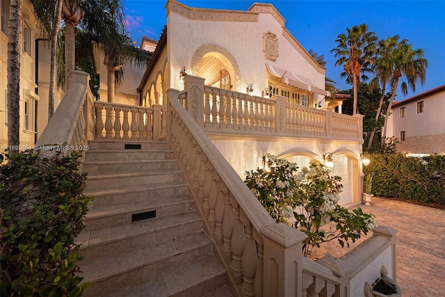 view of front of home featuring a garage and a balcony