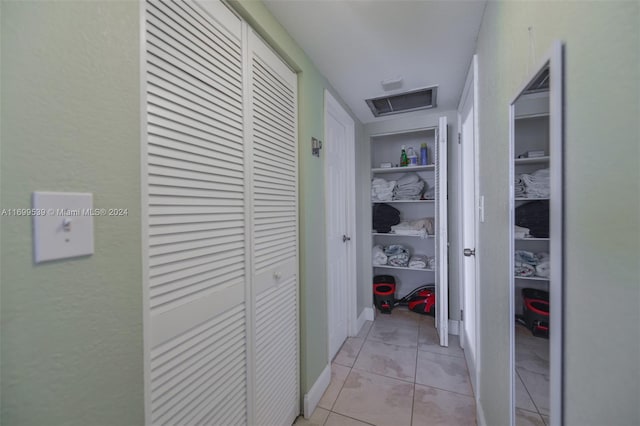 hall with light tile patterned floors