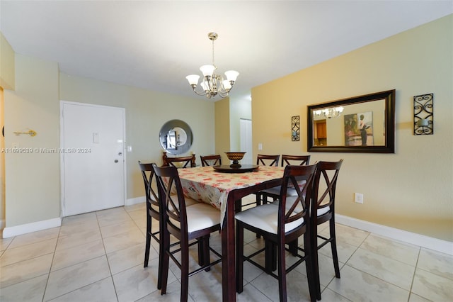 dining area with light tile patterned floors and a chandelier