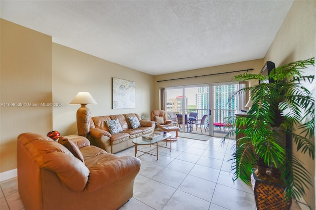 living room with a textured ceiling and light tile patterned flooring