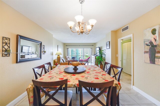 dining area with light tile patterned floors and a notable chandelier