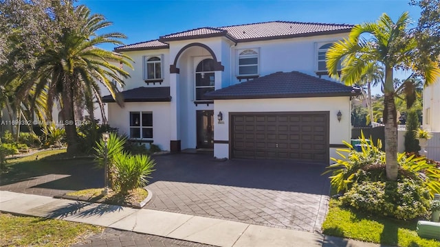 mediterranean / spanish house featuring a garage