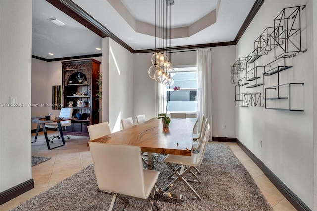 dining area with a tray ceiling, crown molding, light tile patterned floors, and a notable chandelier