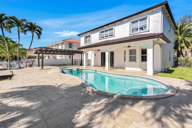 exterior space with a pergola, ceiling fan, a patio, and a pool with hot tub