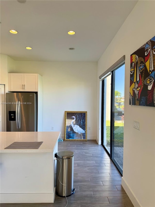 kitchen featuring white cabinetry, stainless steel fridge, and dark wood-type flooring