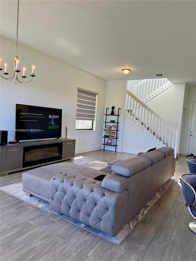 living room with a chandelier and wood-type flooring