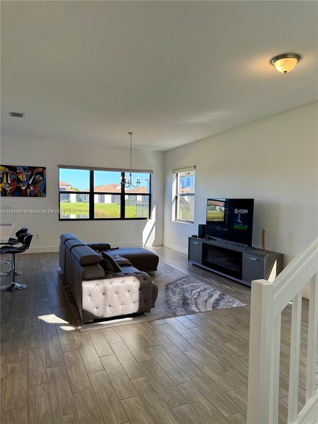 living room with hardwood / wood-style floors and a chandelier