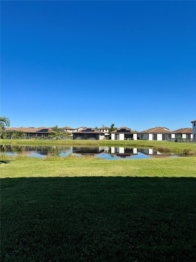 exterior space featuring a water view and a yard