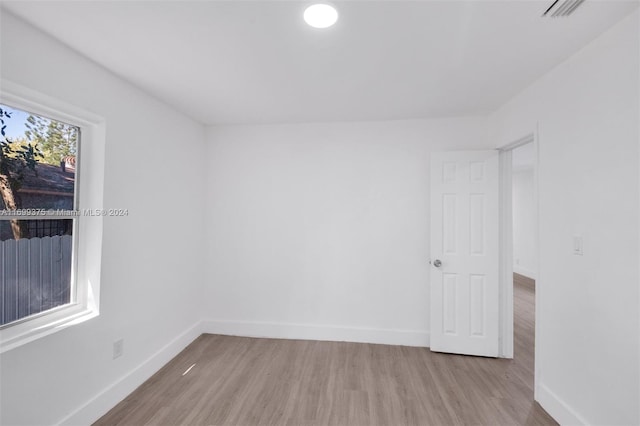 unfurnished room with light hardwood / wood-style flooring