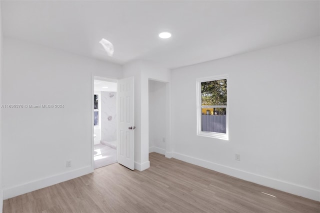 spare room featuring light wood-type flooring