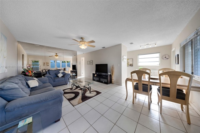 tiled living room featuring a textured ceiling and ceiling fan