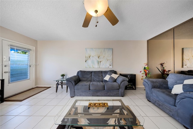 tiled living room featuring ceiling fan and a textured ceiling