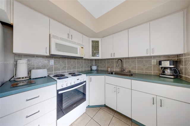 kitchen featuring white cabinetry, sink, backsplash, white appliances, and light tile patterned flooring