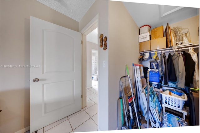 walk in closet with light tile patterned floors