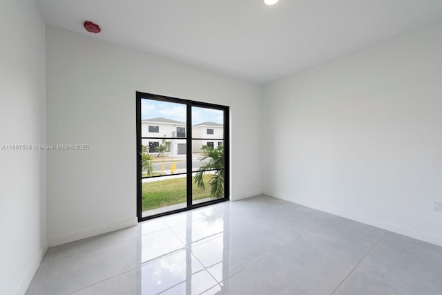 empty room featuring baseboards