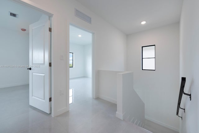 corridor with recessed lighting, an upstairs landing, visible vents, and baseboards