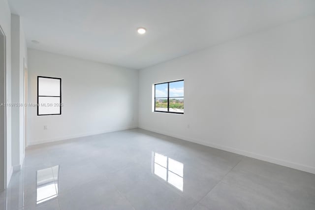 spare room featuring baseboards