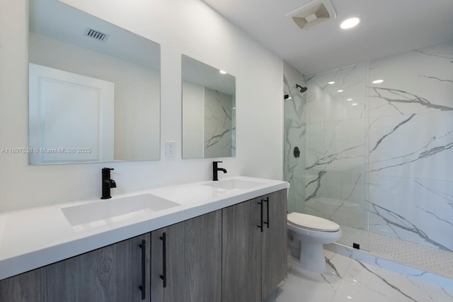 bathroom with toilet, visible vents, marble finish floor, and a sink