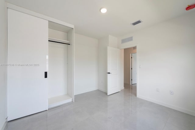 unfurnished bedroom featuring baseboards, visible vents, and a closet