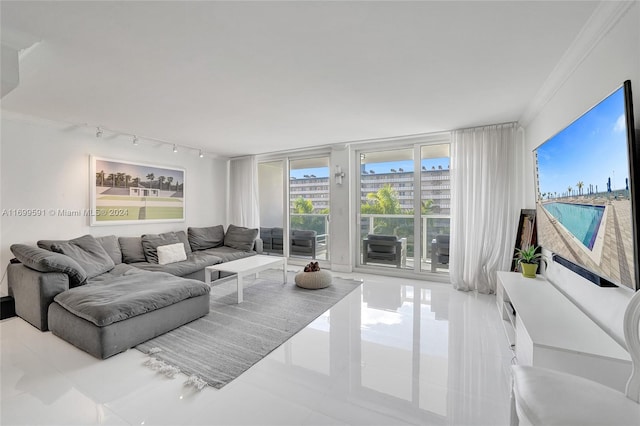 living room with light tile patterned floors and crown molding