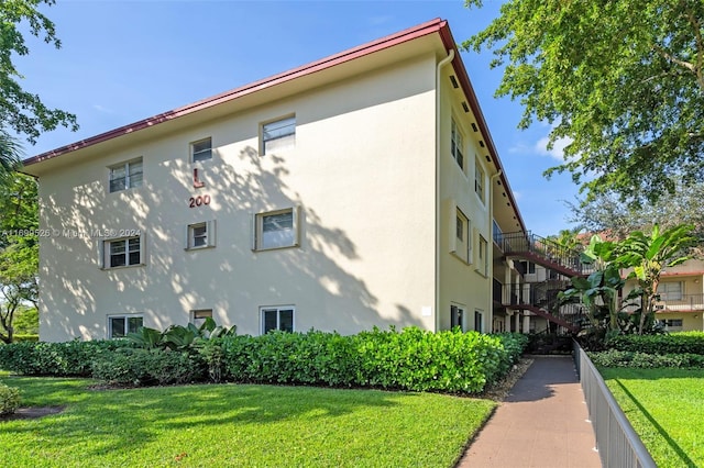 view of home's exterior with a lawn