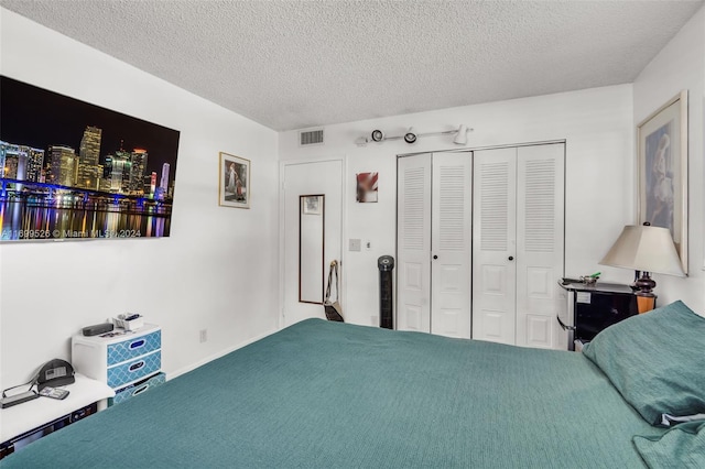 carpeted bedroom featuring a closet and a textured ceiling