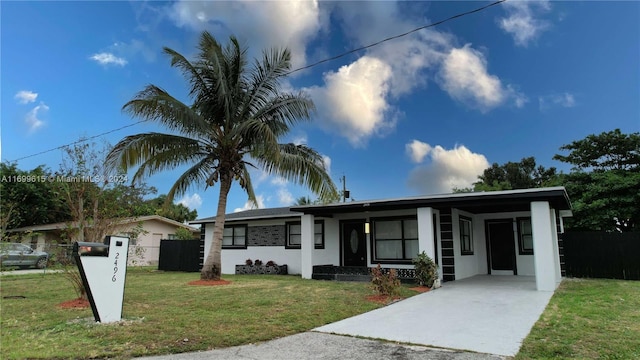 single story home featuring a carport and a front yard