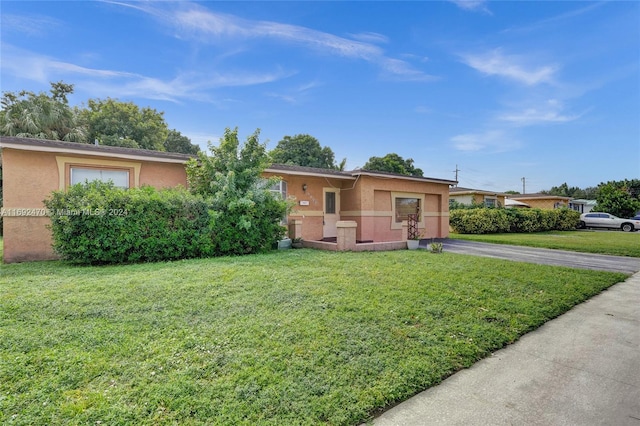 single story home featuring a front yard