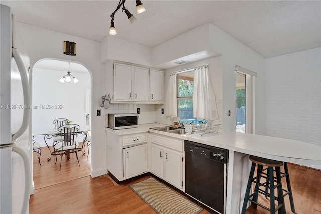 kitchen featuring dishwasher, white cabinets, light hardwood / wood-style flooring, and sink