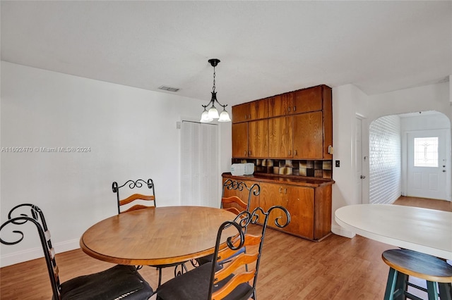 dining space featuring a chandelier and light hardwood / wood-style floors