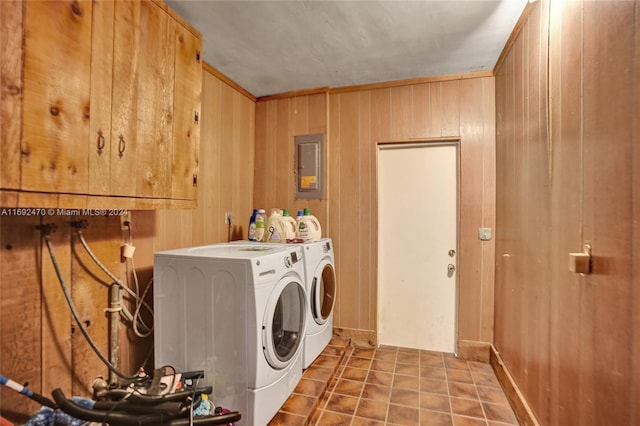 laundry room with washer and clothes dryer, wood walls, crown molding, and electric panel