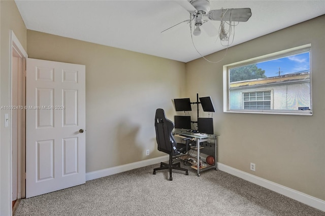 carpeted office space with ceiling fan