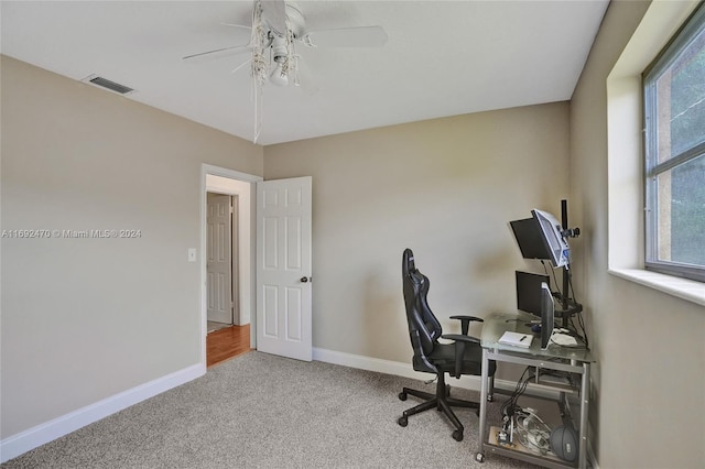 home office featuring light carpet, plenty of natural light, and ceiling fan