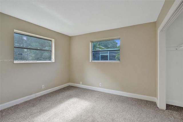 unfurnished bedroom with carpet floors and a closet