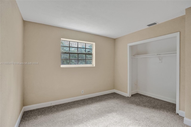 unfurnished bedroom with carpet flooring and a closet