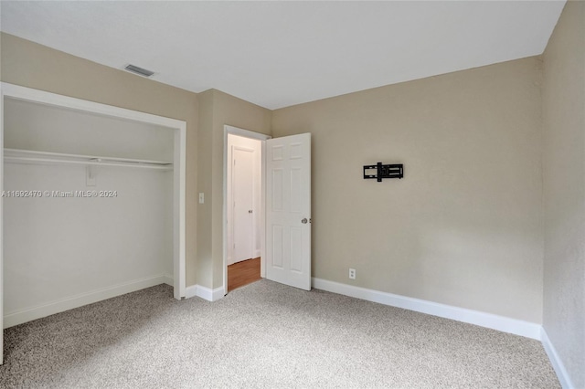 unfurnished bedroom with a closet and carpet