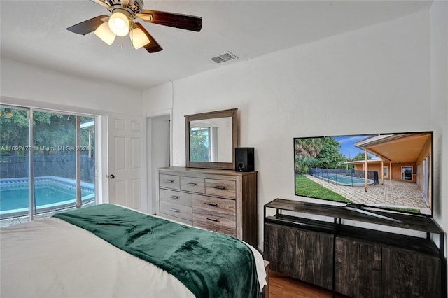 bedroom with hardwood / wood-style floors, ceiling fan, and access to outside