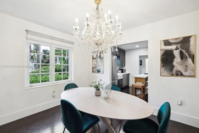 dining space with a notable chandelier and dark hardwood / wood-style floors