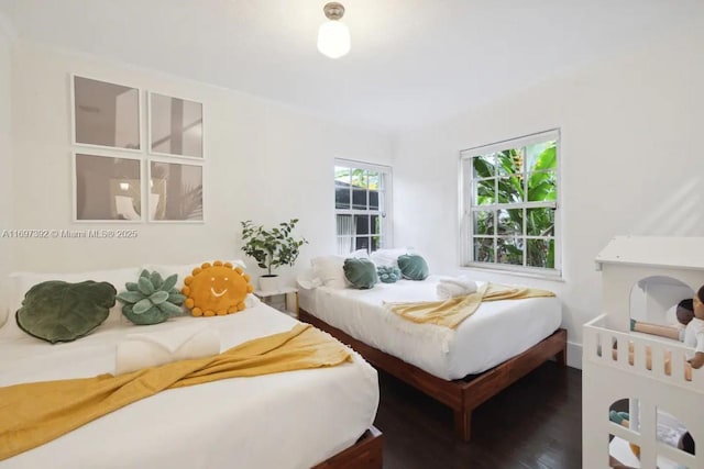 bedroom with dark wood-type flooring