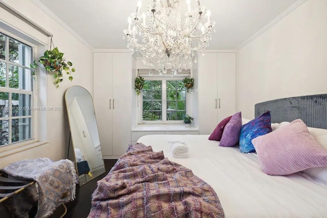 bedroom with ornamental molding, a notable chandelier, and multiple windows