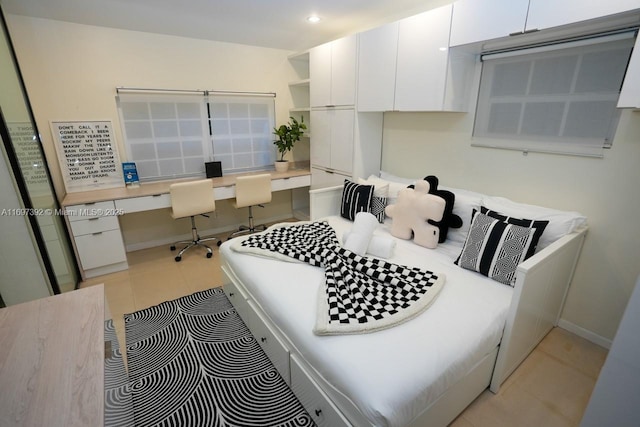 kitchen with dishwasher, built in desk, and white cabinetry