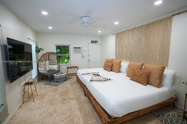 bedroom with ceiling fan and an AC wall unit