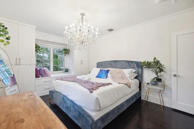 bedroom featuring dark wood-type flooring, an inviting chandelier, and crown molding