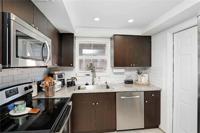 kitchen featuring decorative backsplash, sink, stainless steel appliances, and dark brown cabinets