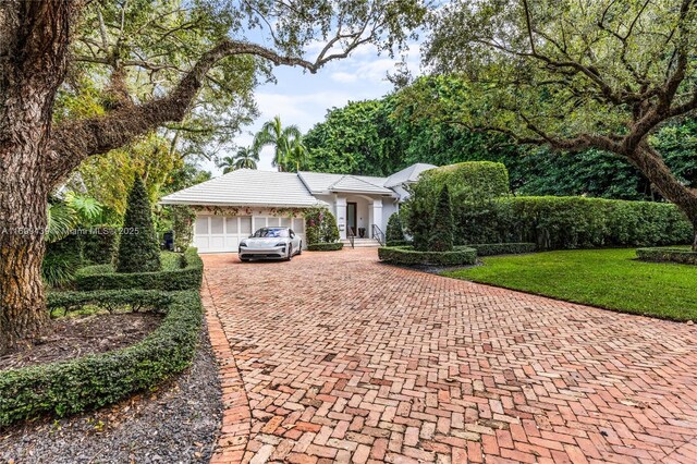 view of front of house with a garage and a front lawn