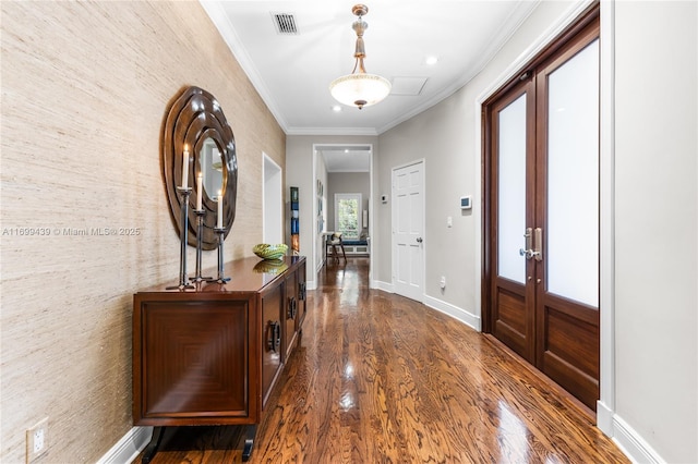 foyer entrance featuring crown molding, dark wood-type flooring, and french doors