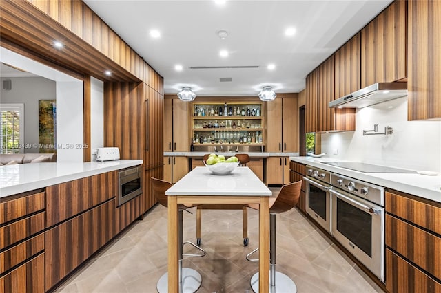 kitchen featuring stainless steel appliances and light tile patterned floors