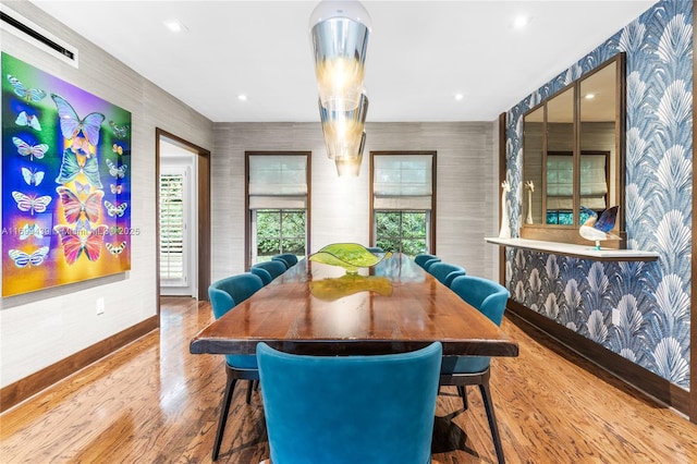 dining space with wood-type flooring