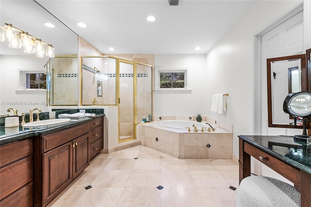 bathroom with shower with separate bathtub, vanity, and tile patterned floors