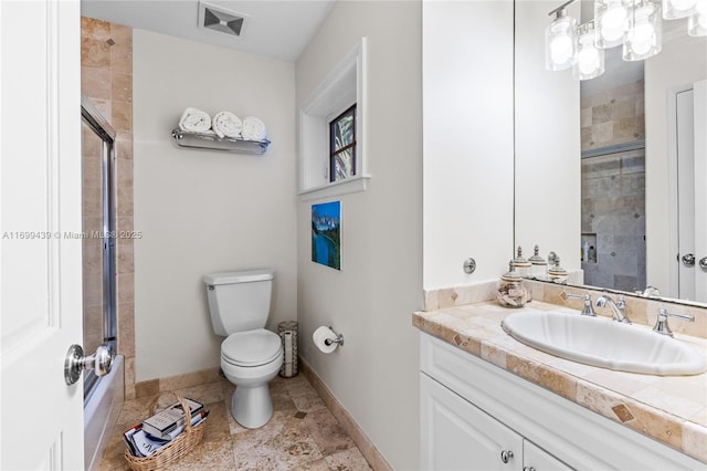 bathroom with vanity, an enclosed shower, and toilet